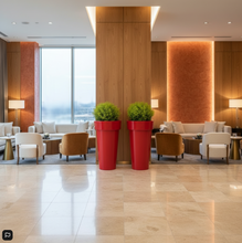 Load image into Gallery viewer, Modern interior with tall Skinny Bigplantpots, vibrant red potted plants, chairs, and a large window.

